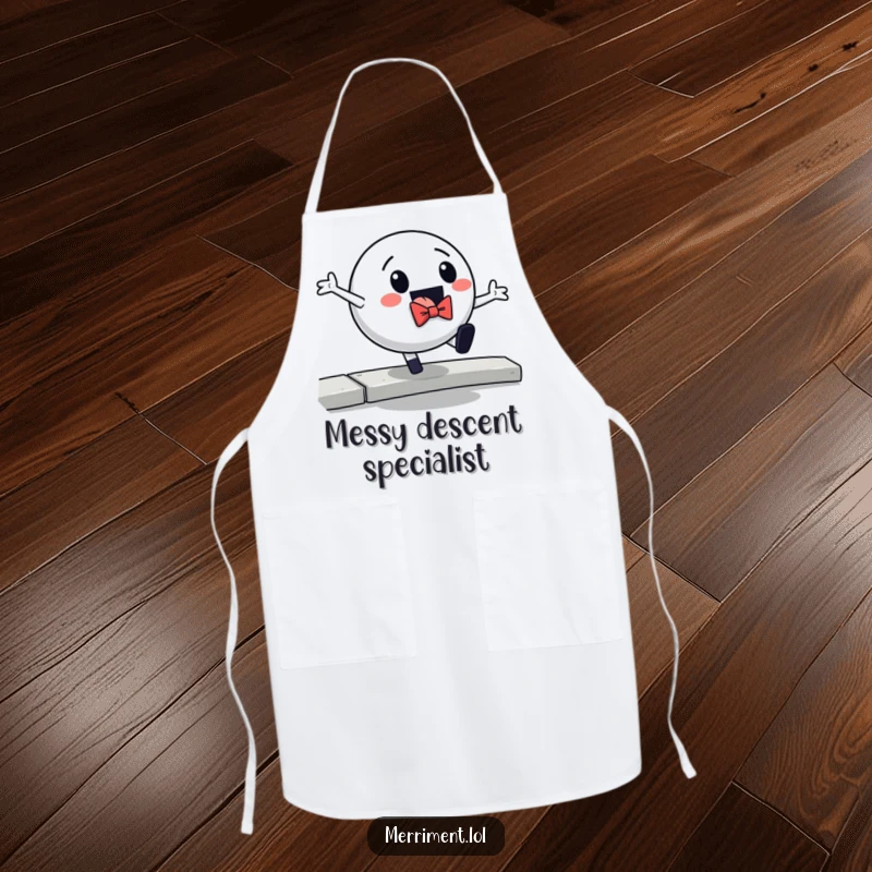 Funny apron showcasing a neatly dressed ball in a bowtie dramatically falling off a curb, bringing humor to kitchen tasks.
