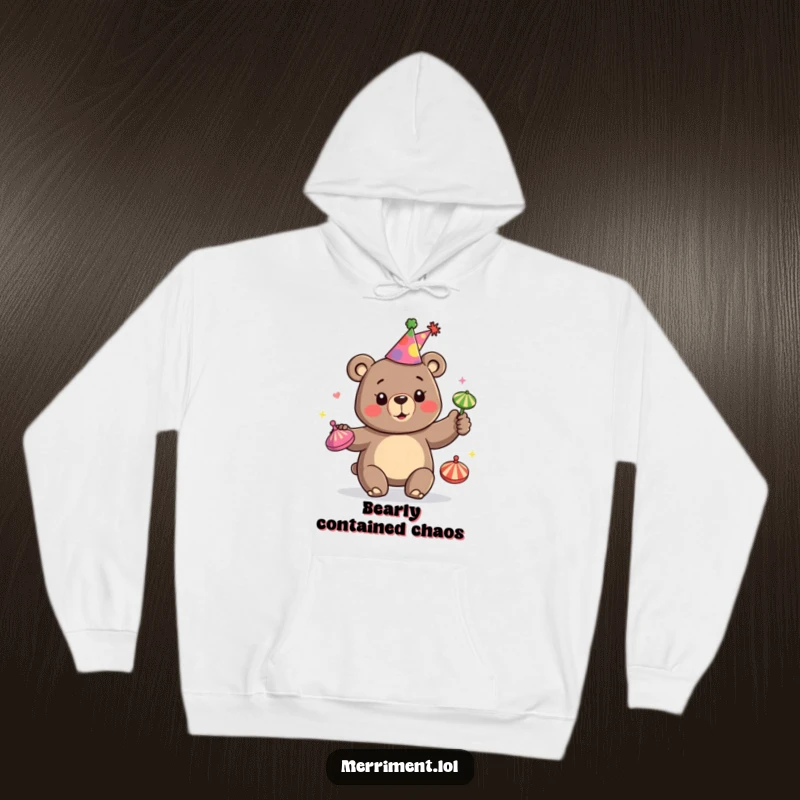 Funny hoodie displaying a happy bear wearing a party hat and juggling colorful spinning tops, perfect for festive, cozy moments.