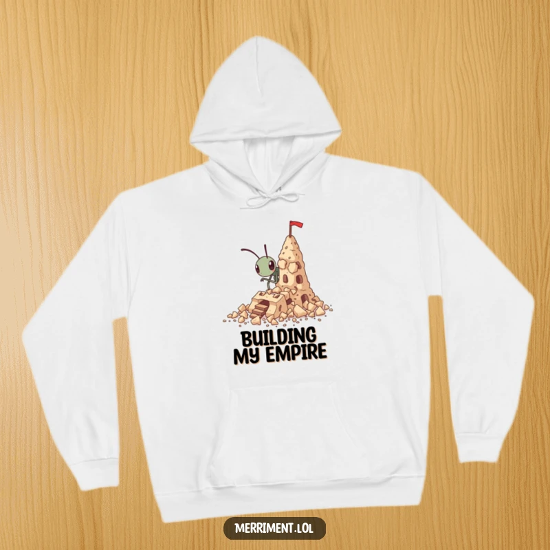Funny tiny ant hoodie building a fortress out of crumbs, cozy and inspiring humorous clothing.