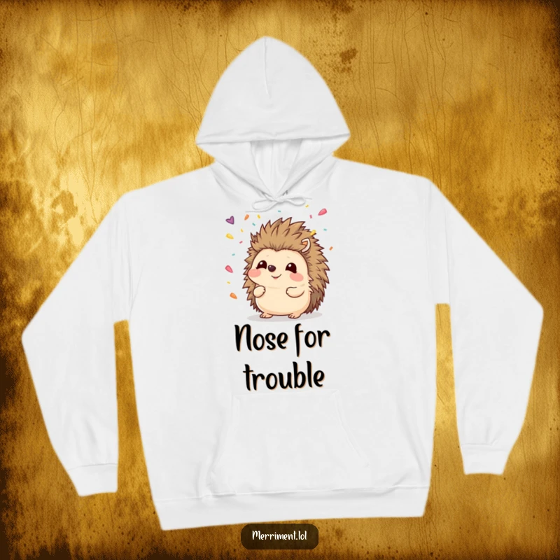 Funny hedgehog hoodie depicting a smiling animal attempting to capture falling confetti with its nose, a warm and witty apparel.