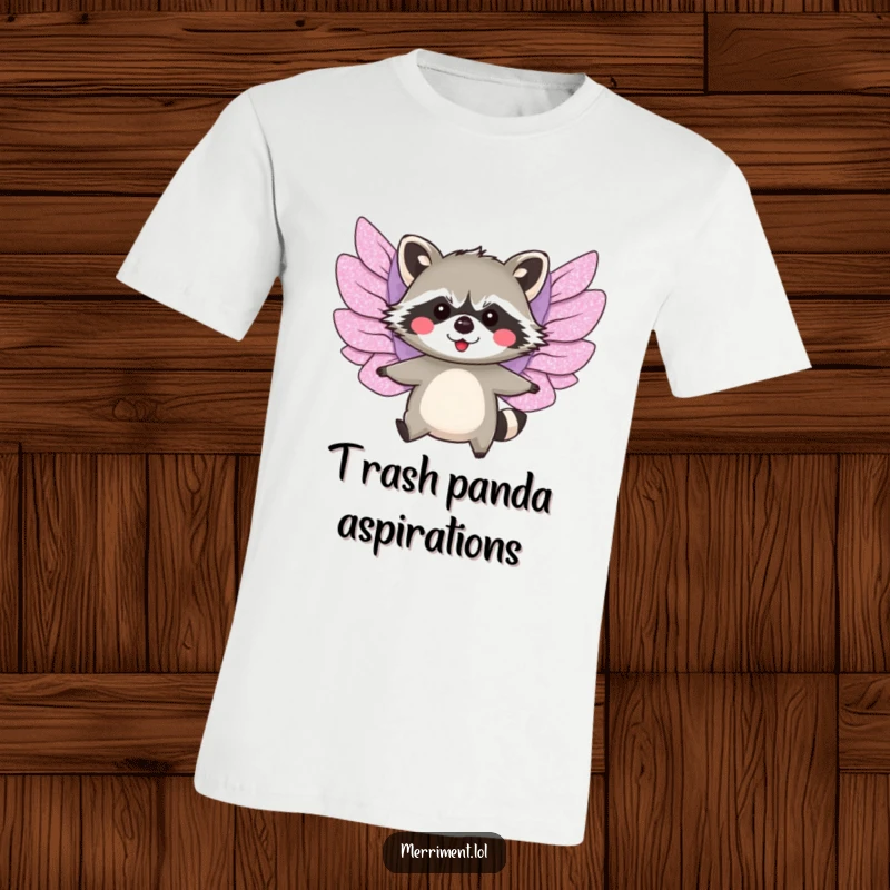 Funny t-shirt depicting a blushing raccoon with large, glittery paper wings attempting a comical flight.