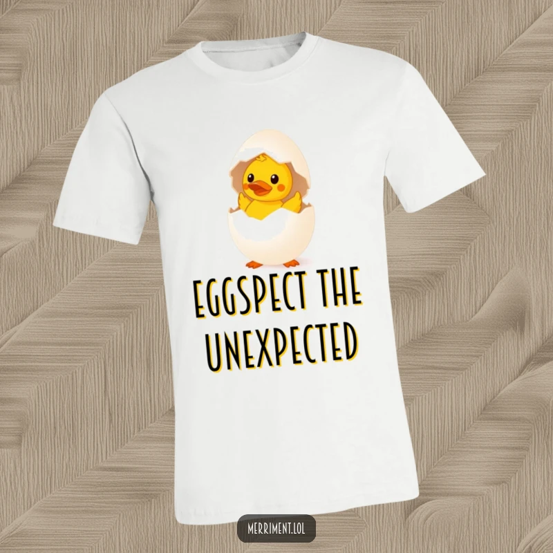 Funny surprised egg t-shirt hatching a tiny rubber duck, a quirky and humorous apparel design.