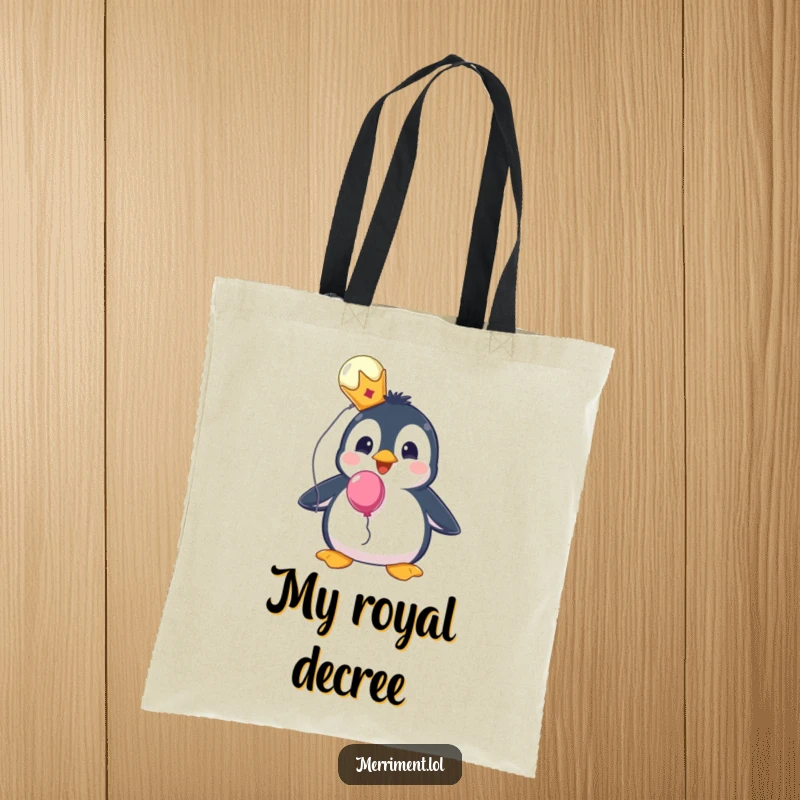 Funny tote bag with a surprised penguin wearing a tiny crown and holding a balloon, ready for errands.