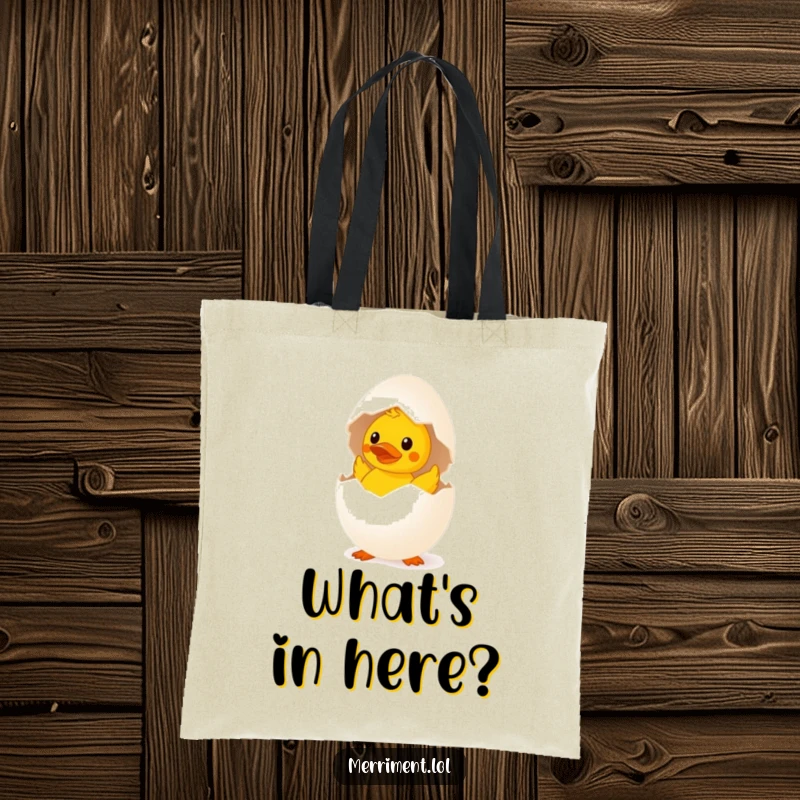 Funny surprised egg tote bag hatching a tiny rubber duck, a humorous and quirky accessory for carrying items.